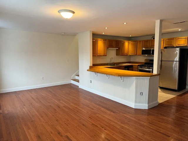 an empty room with wooden floor