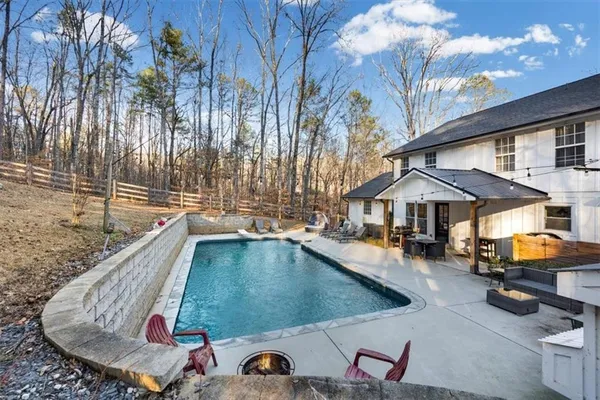 swimming pool view with a seating space