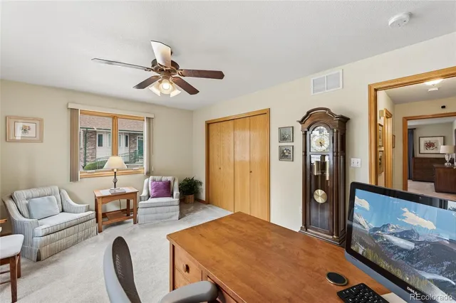 a living room with furniture a chandelier and a flat screen tv