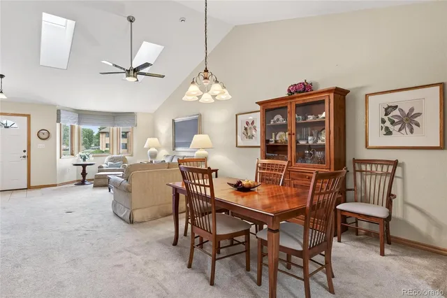 a view of a dining room with furniture and a chandelier