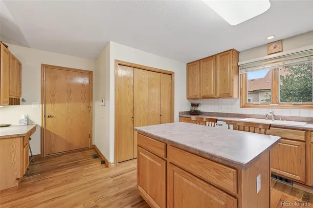 a kitchen with a stove a sink and a refrigerator
