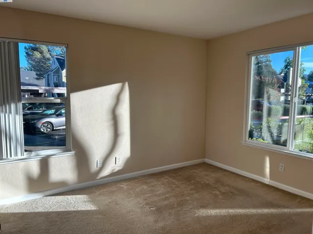 a view of a living room hardwood floor and a large window
