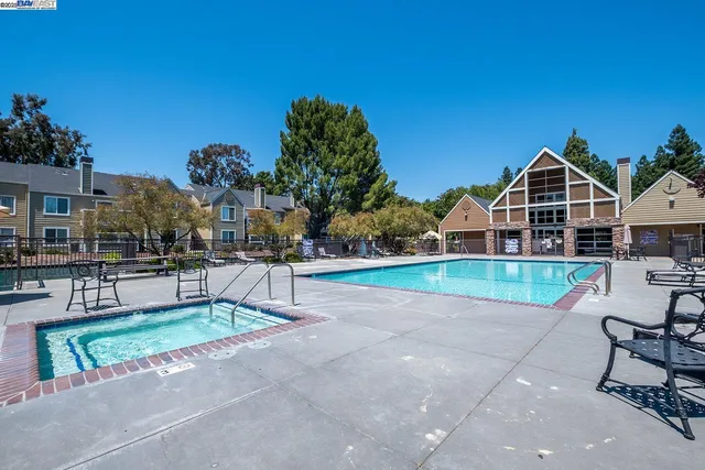 a view of a house with a yard and sitting area