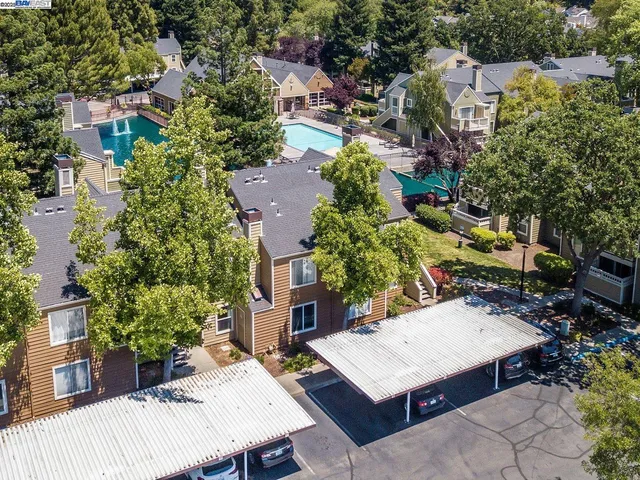 an aerial view of a house with a yard and table