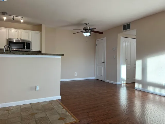 a view of a kitchen with a sink and a refrigerator