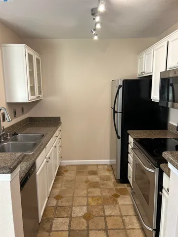a kitchen with a sink a stove a microwave and cabinets