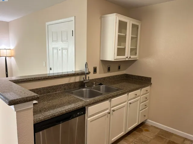 a kitchen with a sink and a window