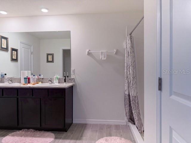 5175 Southwest 47th Lane Gainesville, FL 32608 - Photo 17 of 24 a bathroom with a sink and mirror