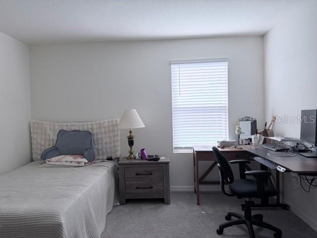 5175 Southwest 47th Lane Gainesville, FL 32608 - Photo 20 of 24 a bedroom with a bed and a desk
