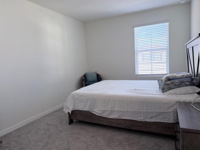 5175 Southwest 47th Lane Gainesville, FL 32608 - Photo 23 of 24 a bedroom with a bed and a window