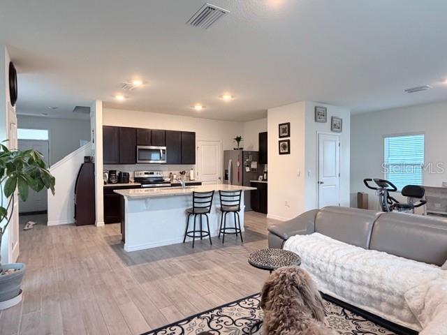5175 Southwest 47th Lane Gainesville, FL 32608 - Photo 7 of 24 a living room with furniture and kitchen view