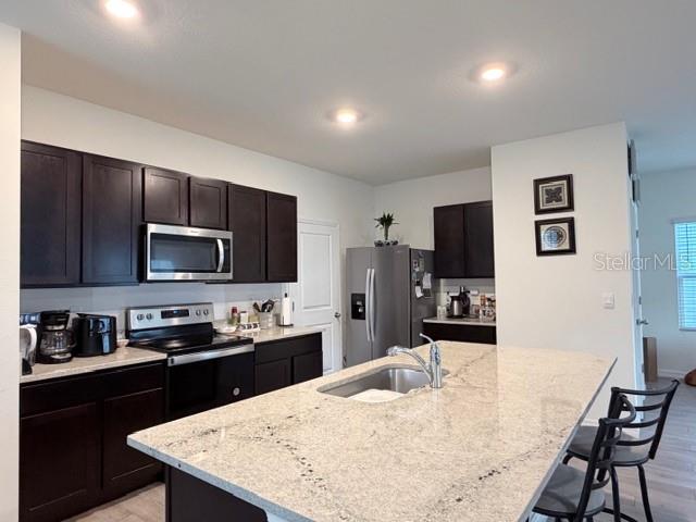 5175 Southwest 47th Lane Gainesville, FL 32608 - Photo 10 of 24 a kitchen with kitchen island a sink stove and refrigerator