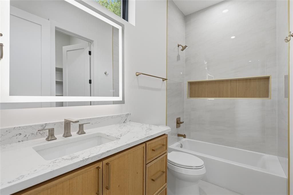 6038 Prospect Avenue Dallas, TX 75206 - Photo 35 of 40 Modern bathroom featuring a wood-finish vanity with an integrated rectangular sink and a quartz countertop