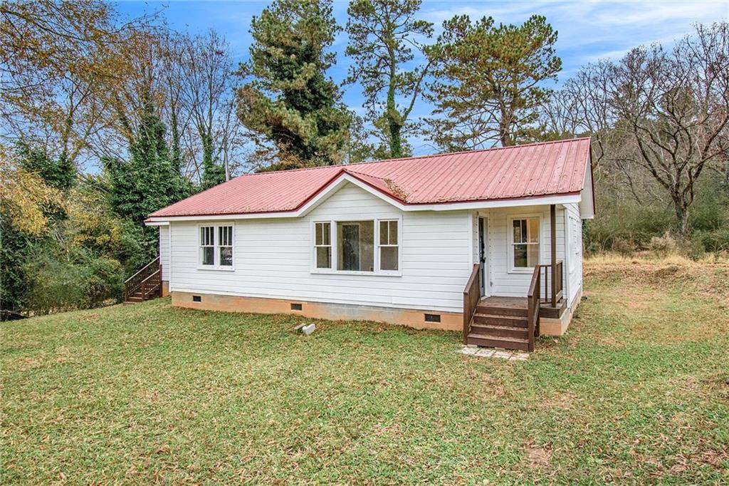 5184 Browns Bridge Road Gainesville, GA 30504 - Photo 1 of 1 a view of a house with a yard and wooden fence