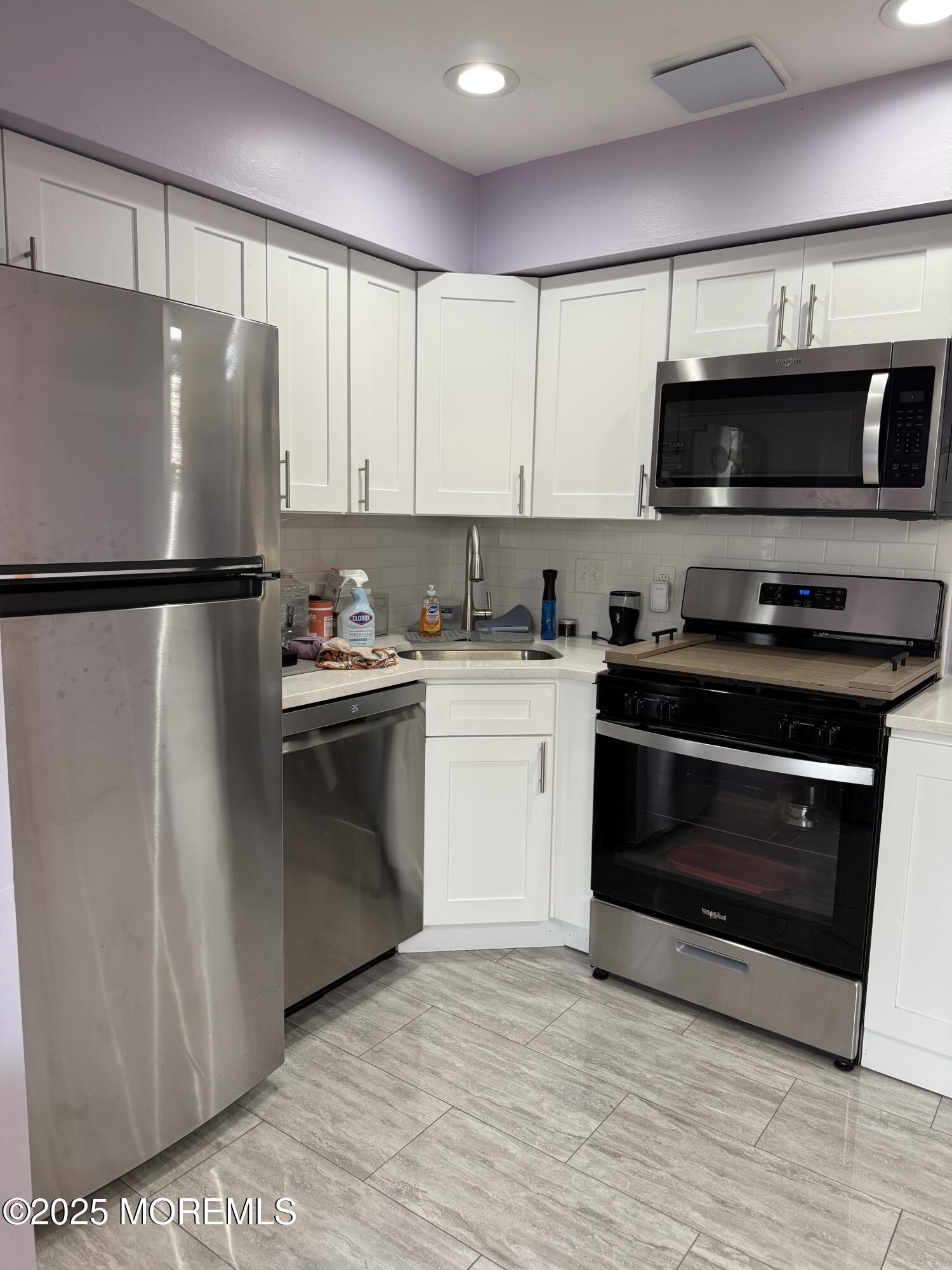 199 Evergreen Road, Unit 8A Edison, NJ 08837 - Photo 3 of 8 a kitchen with a refrigerator stove and microwave