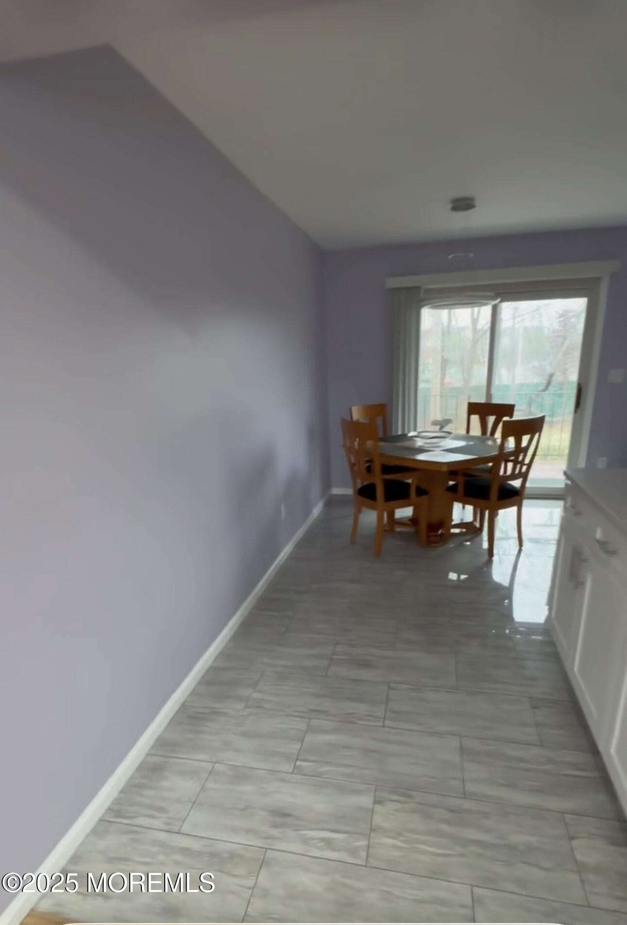 199 Evergreen Road, Unit 8A Edison, NJ 08837 - Photo 4 of 8 a view of a dining room with furniture window and outside view