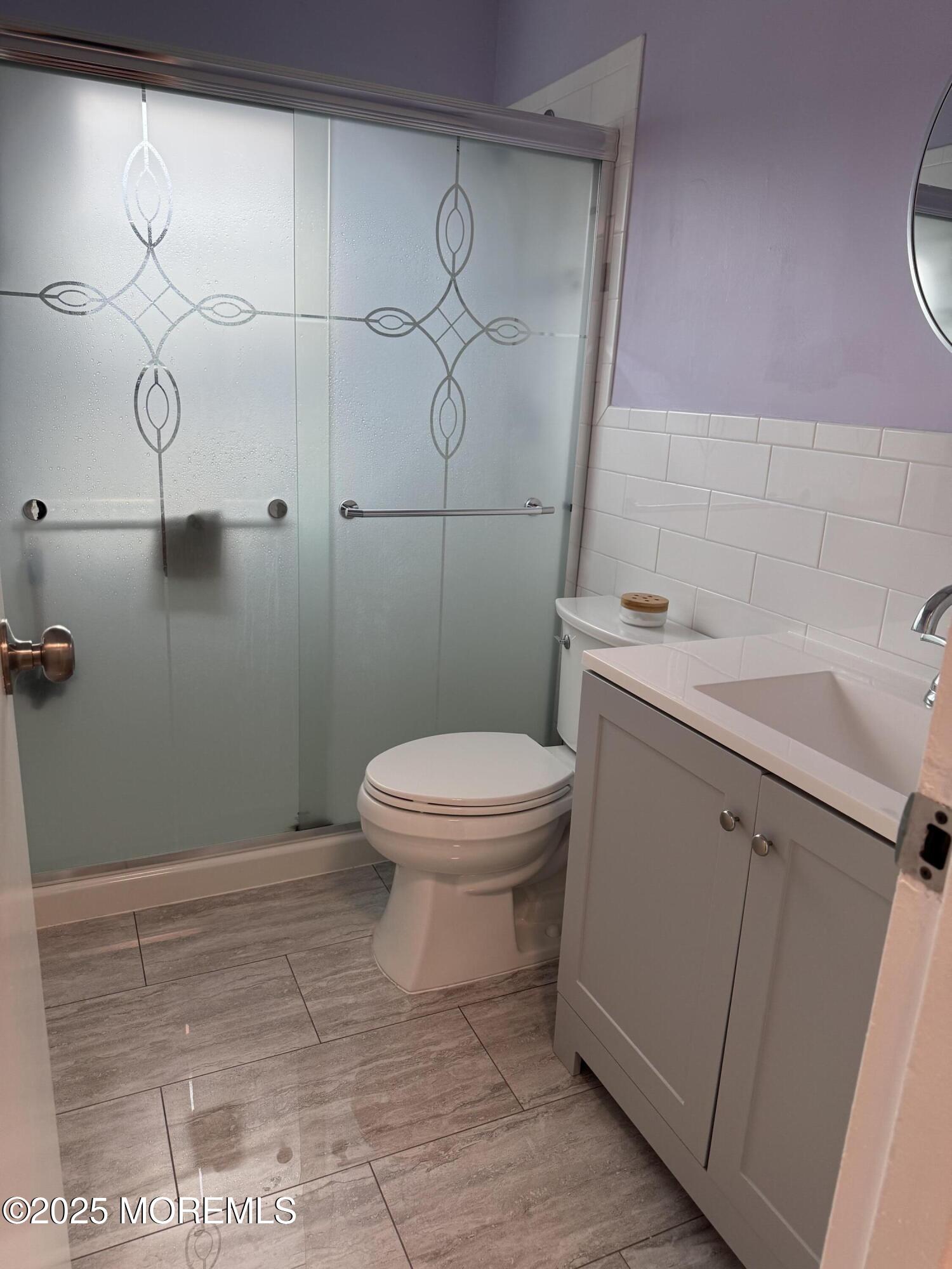 199 Evergreen Road, Unit 8A Edison, NJ 08837 - Photo 6 of 8 a bathroom with a toilet sink and vanity