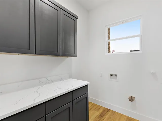 a view of a room with wooden floor and white walls