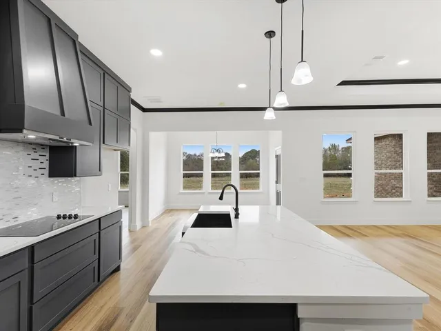 a view of a kitchen with cabinets stainless steel appliances and wooden floor
