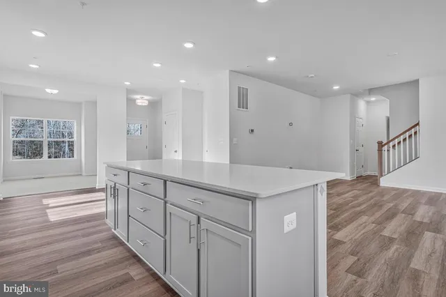 a kitchen with stainless steel appliances granite countertop a refrigerator sink and stove