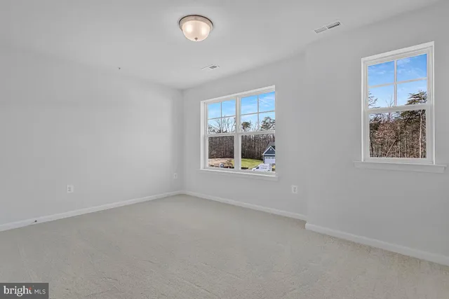 a view of an empty room and a window