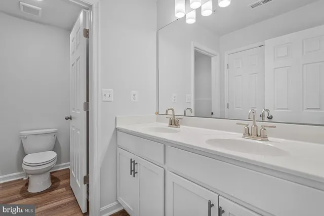 a view of a hallway with wooden floor and entryway