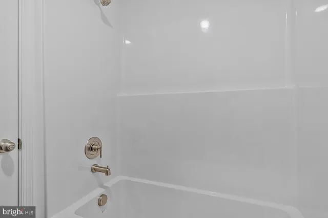 a bathroom with a toilet a sink a mirror and vanity