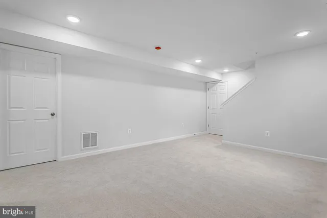 an empty room with windows and closet