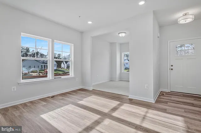 a large white kitchen with a sink and cabinets