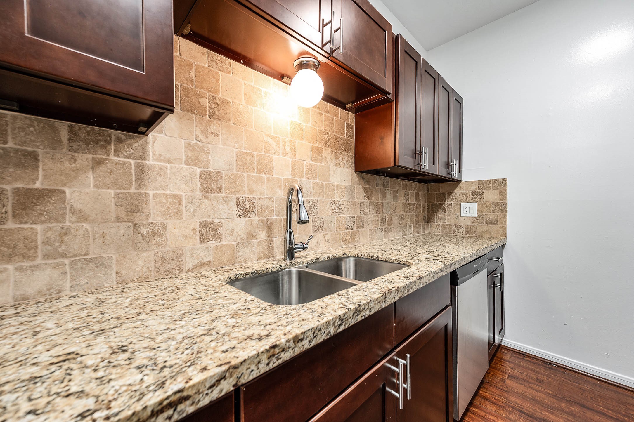 6000 Reims Road, Unit 2003 Houston, TX 77036 - Photo 9 of 24 a kitchen with granite countertop sink and cabinets