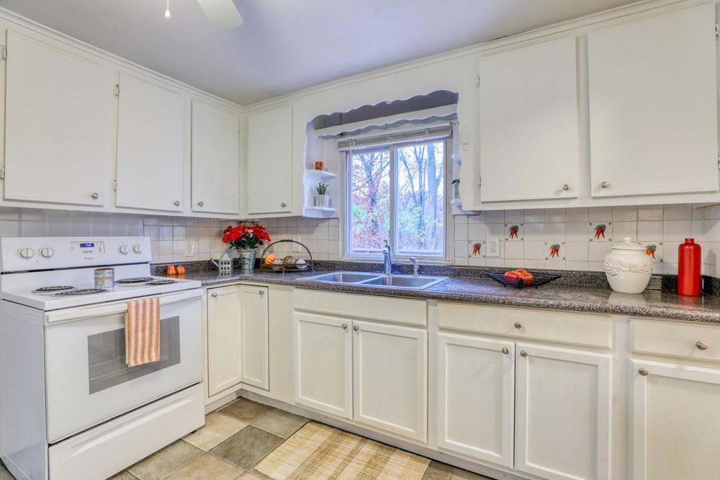 40 Truman Circle Springfield, MA 01109 - Photo 3 of 13 a kitchen with granite countertop white cabinets and white appliances