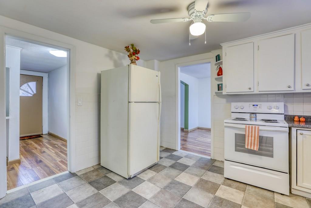 40 Truman Circle Springfield, MA 01109 - Photo 4 of 13 a kitchen with a refrigerator a stove top oven and cabinets