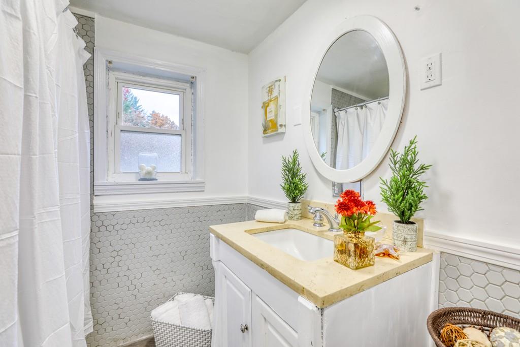 40 Truman Circle Springfield, MA 01109 - Photo 7 of 13 a bathroom with a sink mirror and vanity