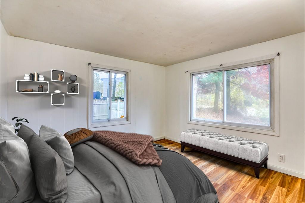 40 Truman Circle Springfield, MA 01109 - Photo 8 of 13 a bedroom with a bed and wooden floor