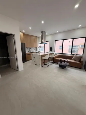 a view of a livingroom with furniture and a window