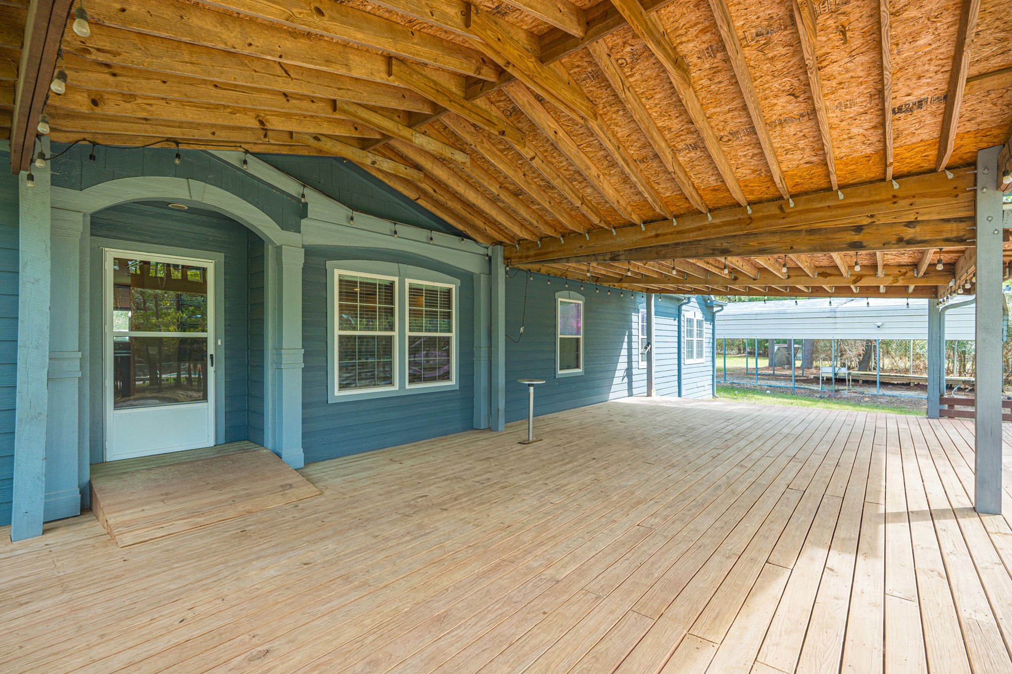 115 Canadian Drive Trinity, TX 75862 - Photo 6 of 41 This spacious covered porch features a wooden deck and perfect for outdoor entertaining and relaxation.