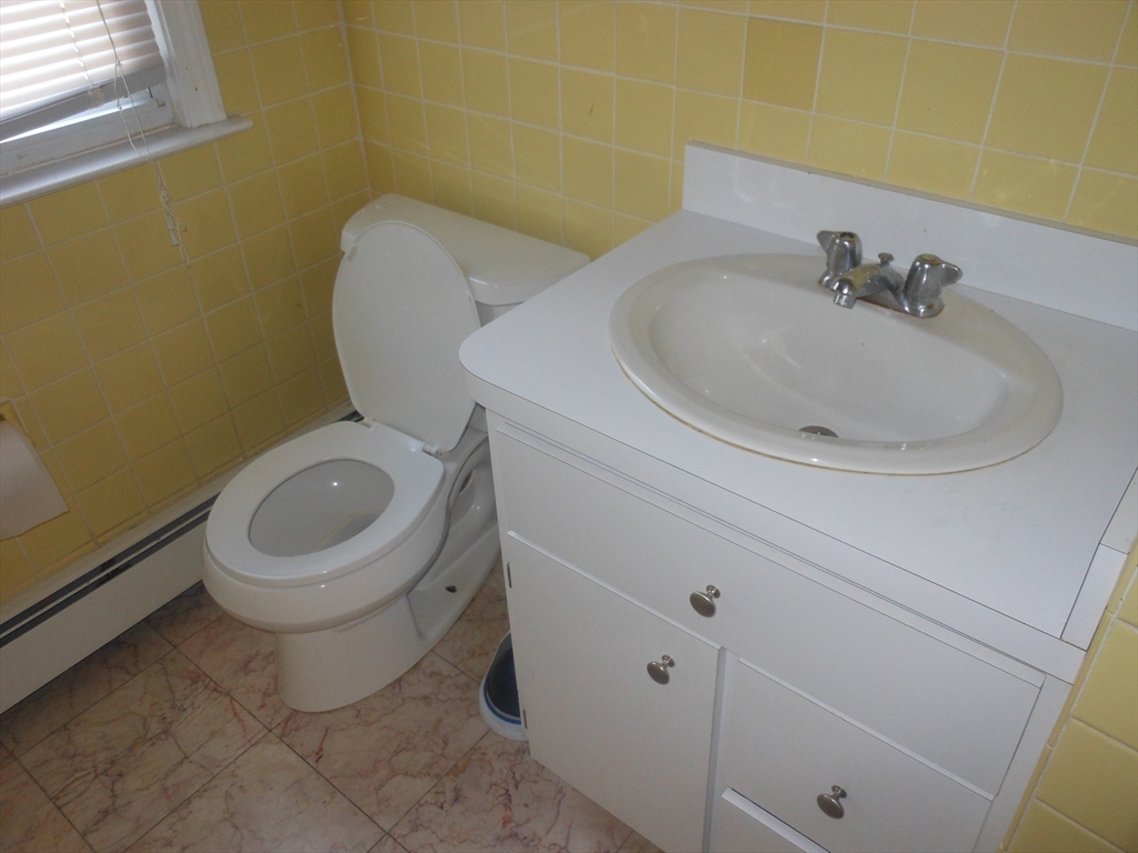 21 Cook, Unit 1 Chelsea, MA 02150 - Photo 28 of 32 a bathroom with a toilet and a sink