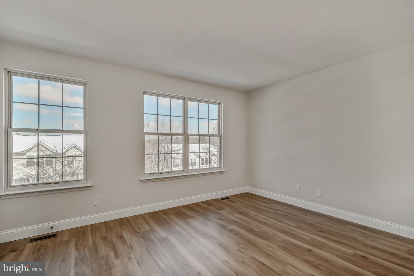 24 Mill Court Pine Hill, NJ 08021 - Photo 19 of 19 an empty room with wooden floor and windows