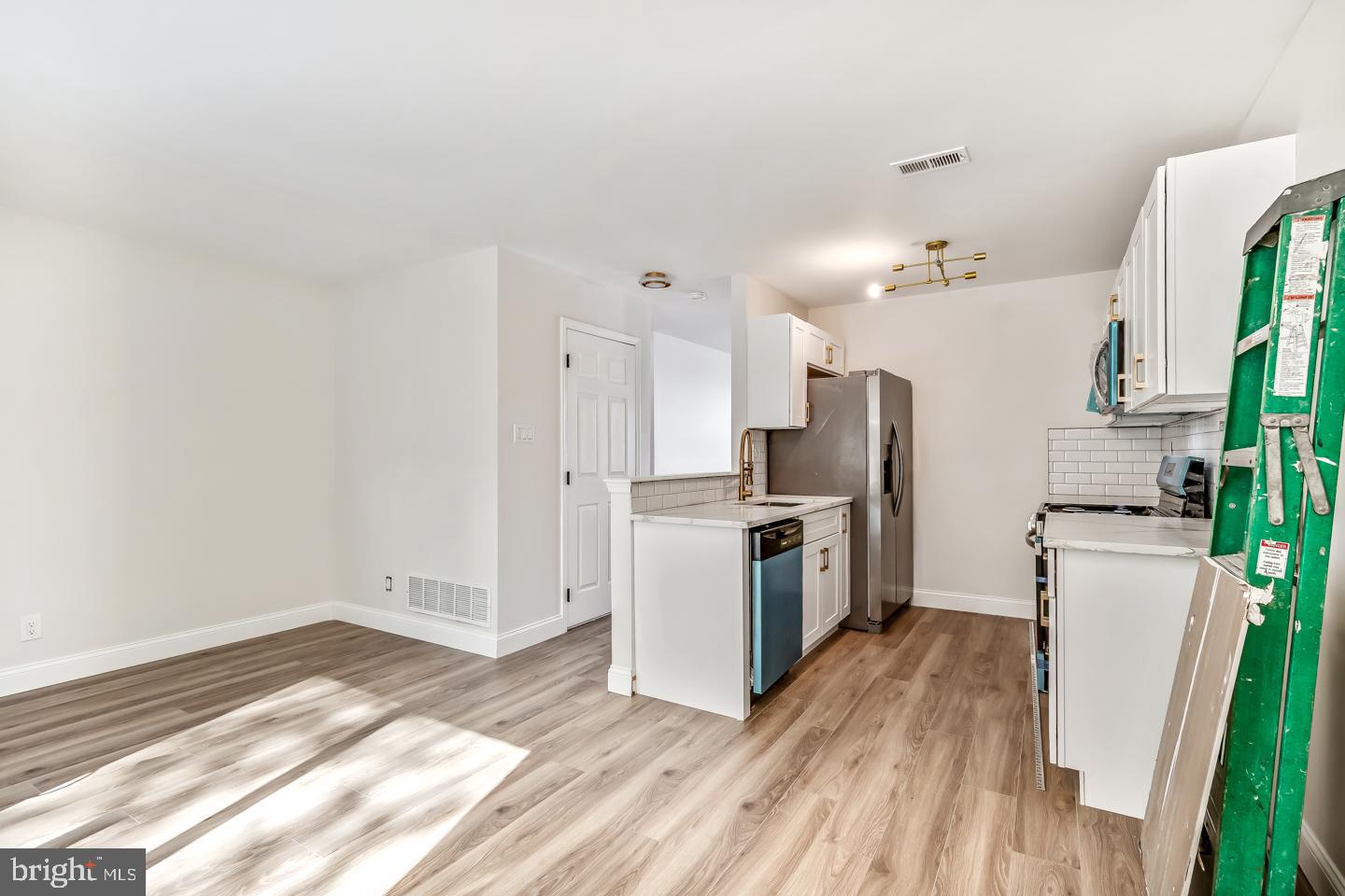 24 Mill Court Pine Hill, NJ 08021 - Photo 4 of 19 a kitchen with a refrigerator a stove top oven a sink and dishwasher