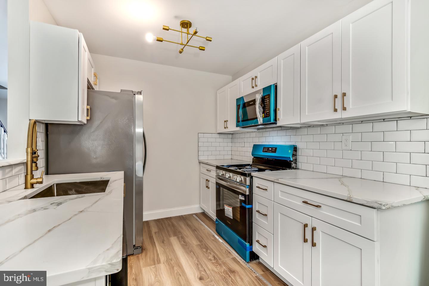 24 Mill Court Pine Hill, NJ 08021 - Photo 5 of 19 a kitchen with stainless steel appliances granite countertop a stove a sink and a refrigerator
