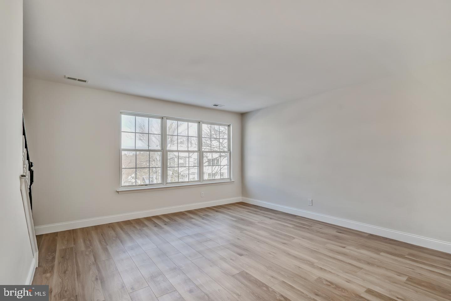 24 Mill Court Pine Hill, NJ 08021 - Photo 8 of 19 an empty room with wooden floor and windows