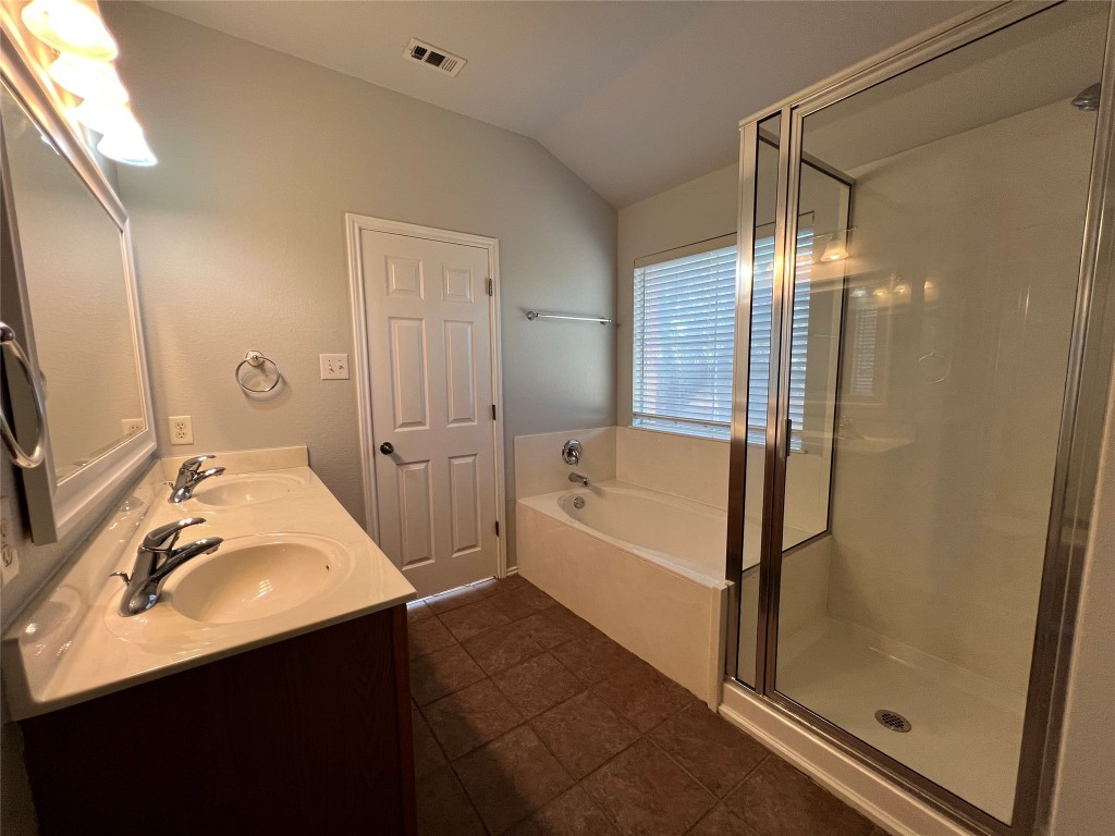 9301 Muskberry Cove Austin, TX 78717 - Photo 15 of 23 a bathroom with a sink vanity granite tub shower and mirror