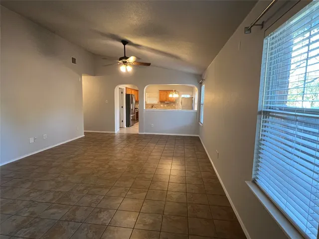 a view of a hallway with wooden floor and windows