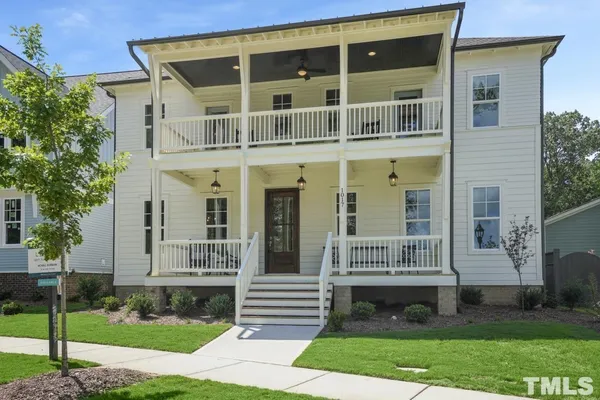a front view of a house with a yard and porch