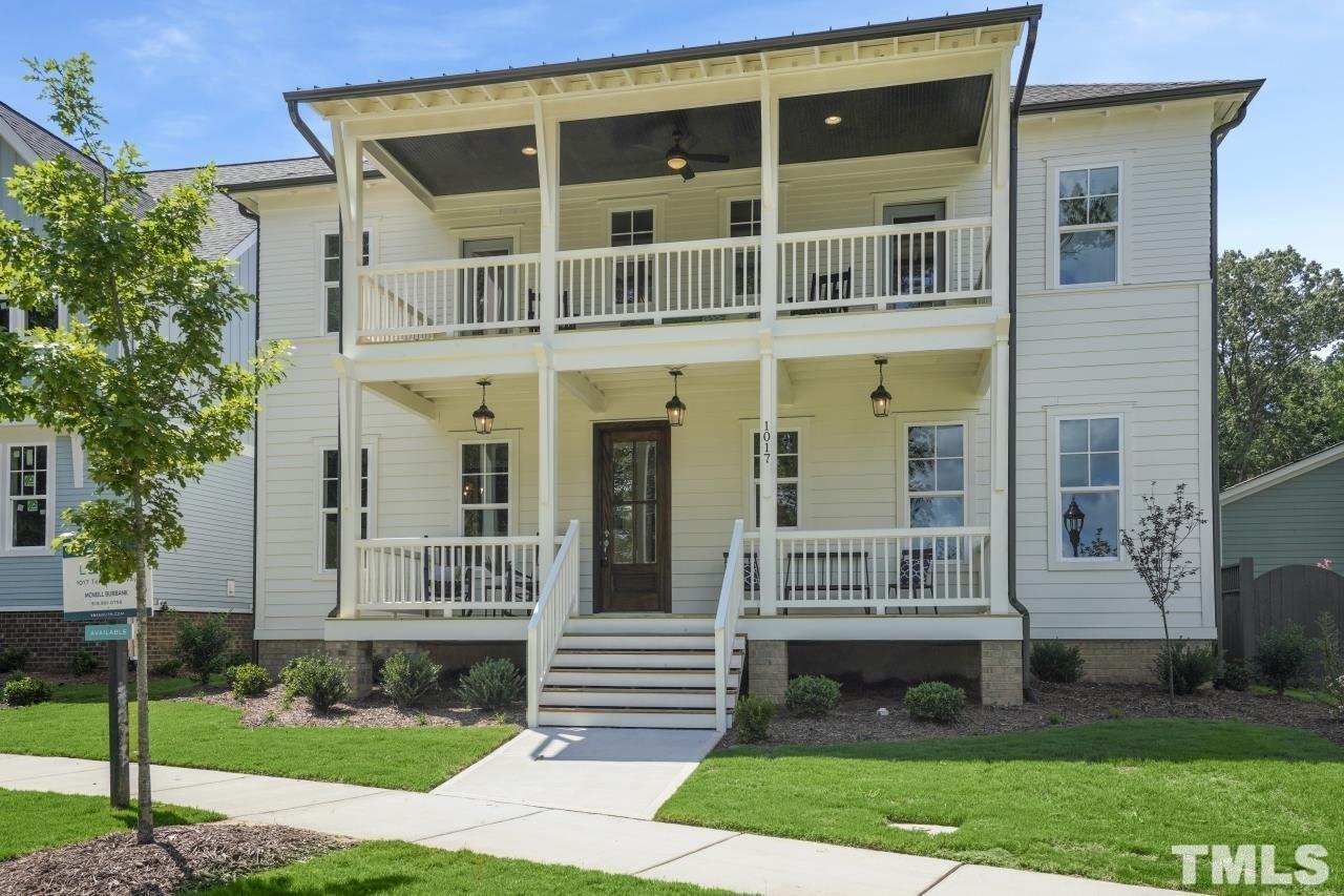 a front view of a house with a yard and porch