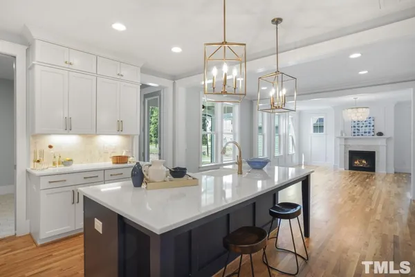 a kitchen with sink cabinets and wooden floor