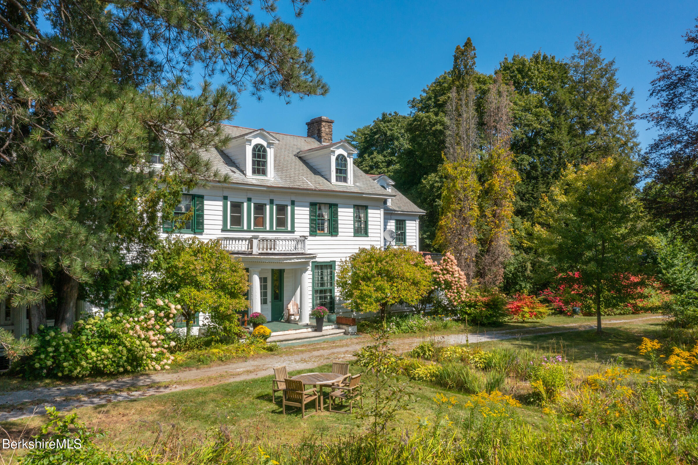 535 Main Road Monterey, MA 01245 - Photo 8 of 45 a front view of a house with a yard and trees