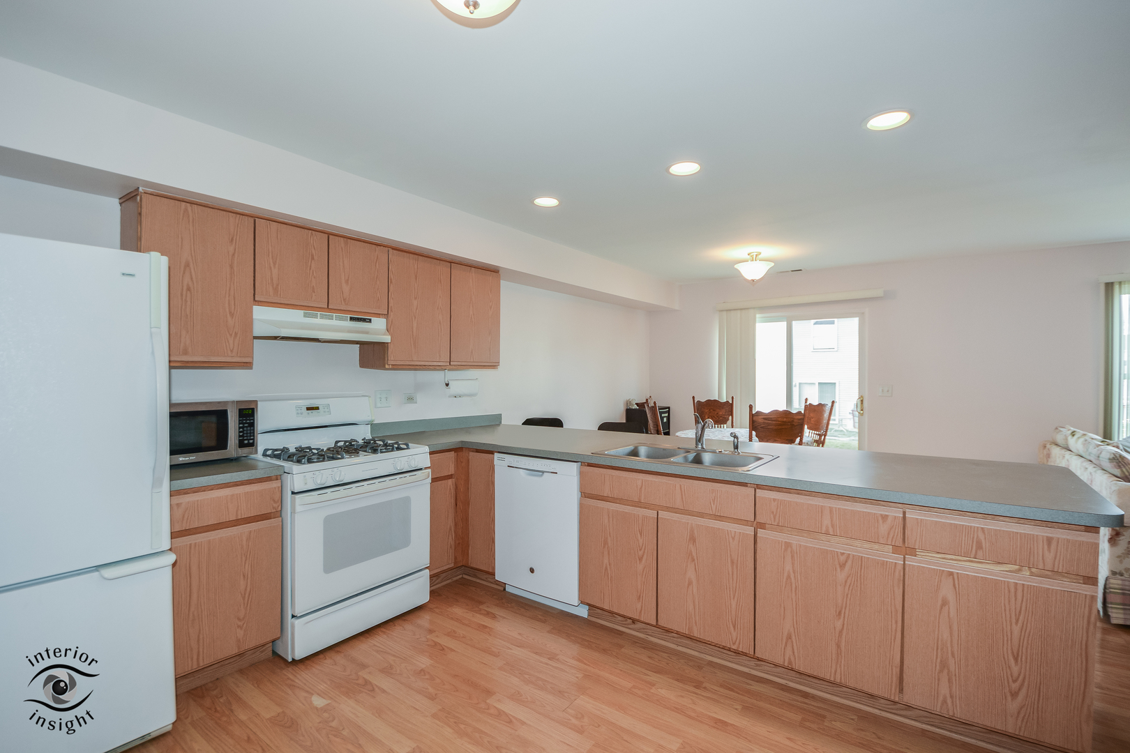 25216 Faraday Road Manhattan, IL 60442 - Photo 4 of 23 a kitchen with white cabinets sink and white appliances