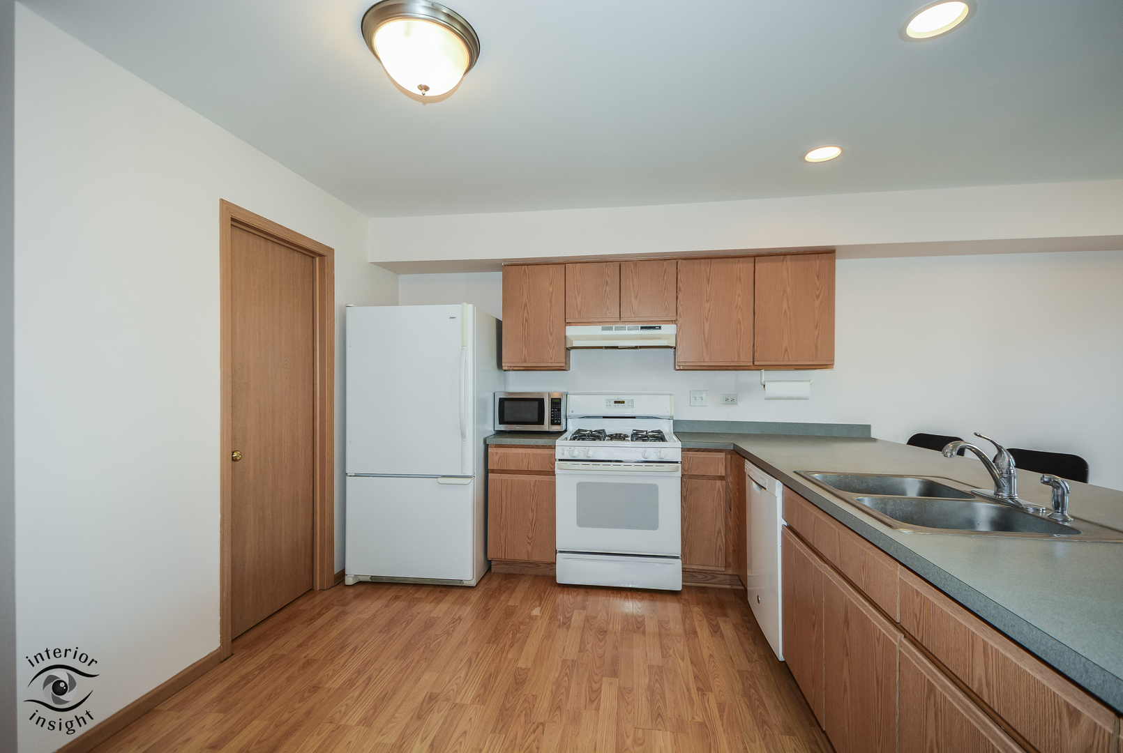 25216 Faraday Road Manhattan, IL 60442 - Photo 6 of 23 a kitchen with a sink cabinets stainless steel appliances and a window