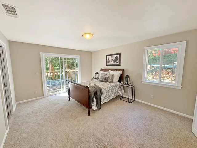 a spacious bedroom with a bed and a window